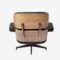 Close-up view of Eames lounge chair replica highlighting ash wood texture and curved armrest