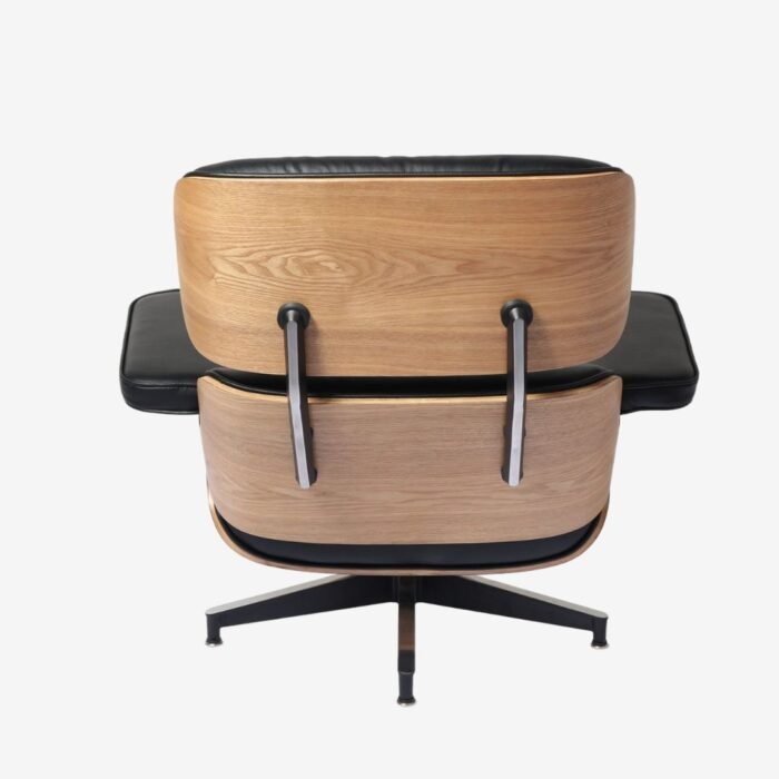 Close-up view of Eames lounge chair replica highlighting ash wood texture and curved armrest