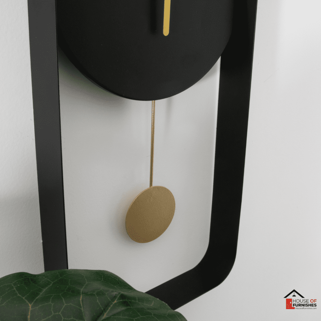 Matte Black Metal Wall Clock with Gold Details in Modern Interior Setting