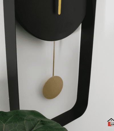 Matte Black Metal Wall Clock with Gold Details in Modern Interior Setting