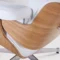 Close-up of the natural ash wood grain on the back of a classic Eames chair lounge chair.